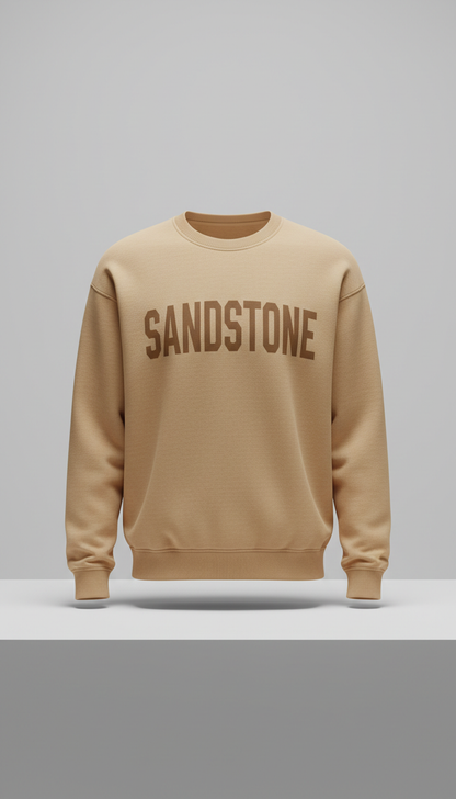 Sandstone bold typography sweatshirt, Single-product focus: hero garment displayed on matte plinth or hanger against...