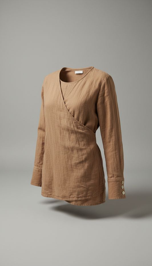 A warm taupe shirt from Nature's Canvas is displayed against a pebble grey background. The shirt is positioned at a 3/4...
