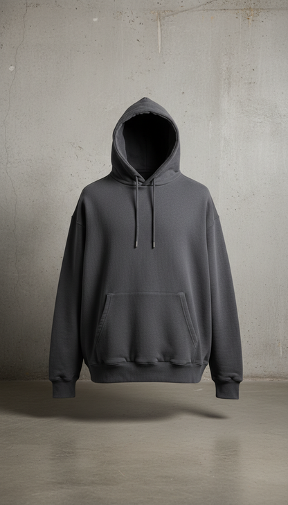 A perfectly centered product shot of a Charcoal Gray heavyweight hoodie at eye-level with a slight angle, highlighting...