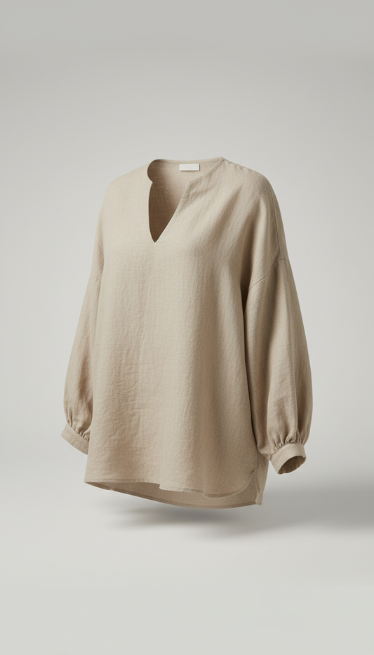A perfectly centered beige linen blouse is showcased in a classic 3/4 angle against a neutral light gray backdrop. The...
